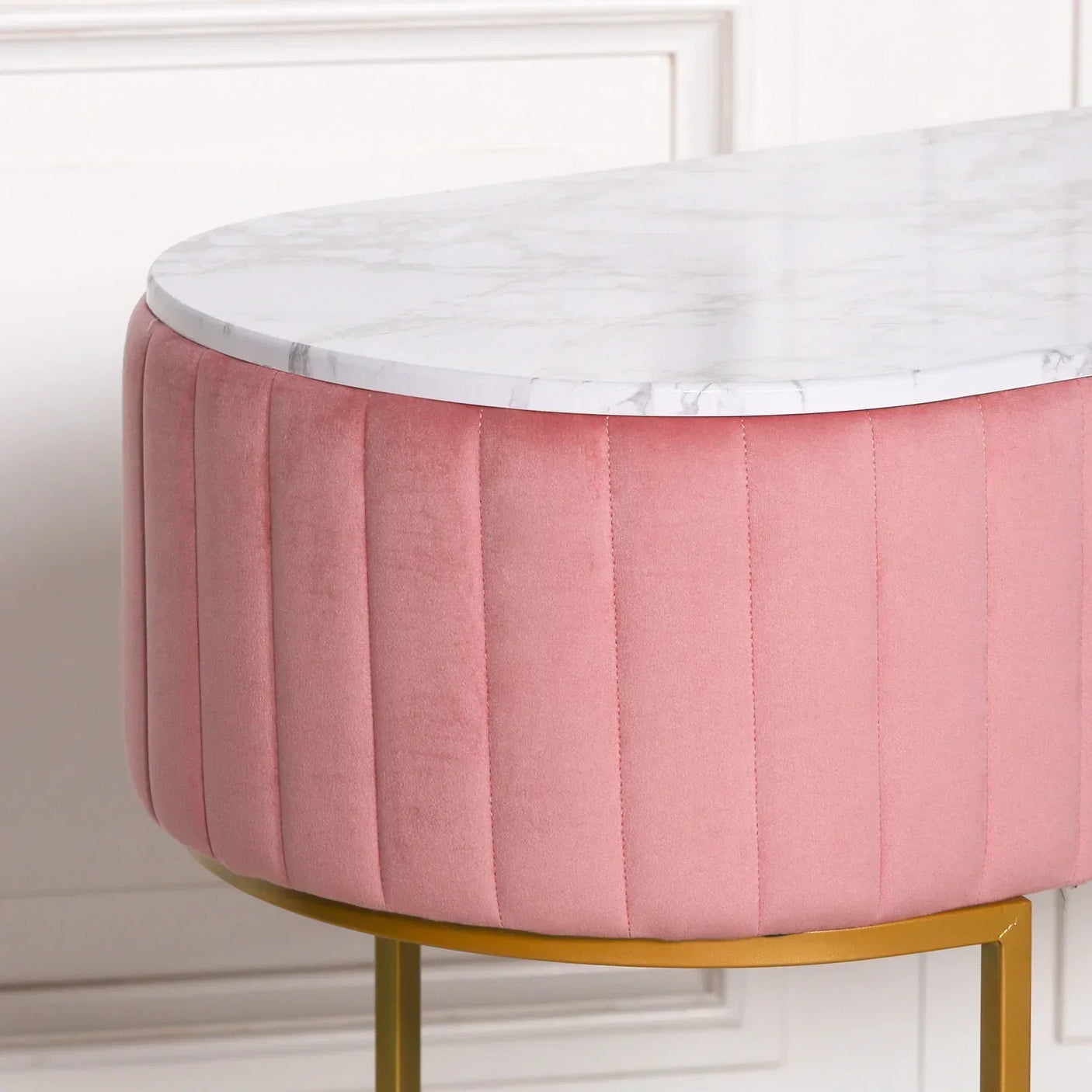 Pink velvet accent table with white marble top and gold metal legs close-up