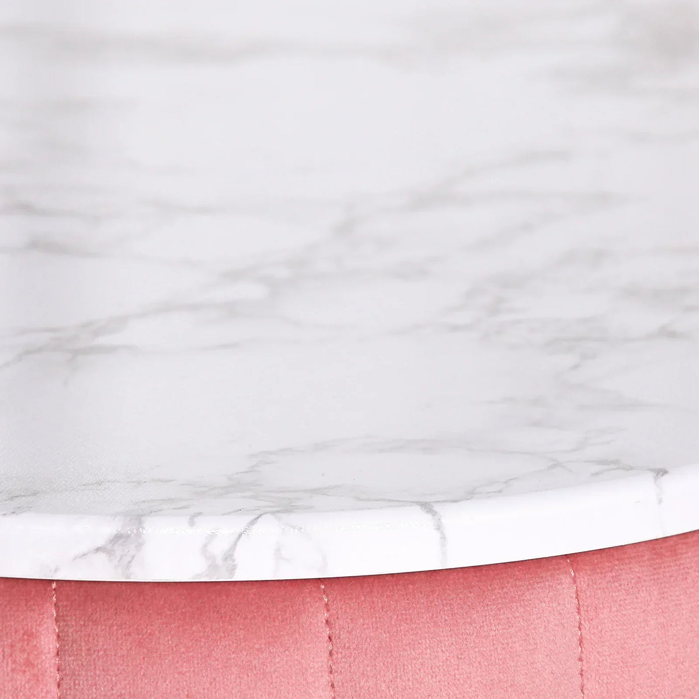 Round marble effect tabletop on blush pink velvet stool closeup