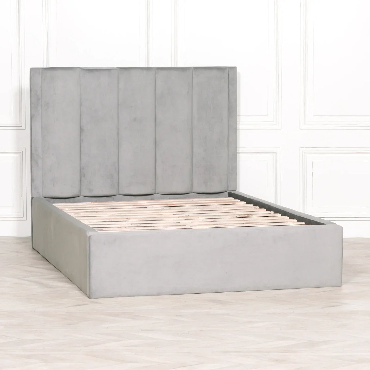 Grey upholstered bed frame with vertical panel headboard and wooden slats