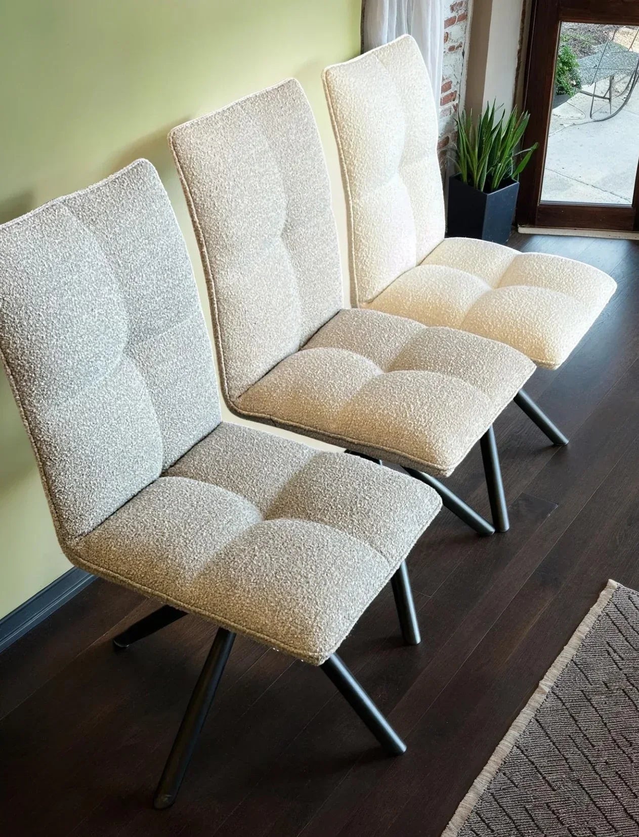 Grey, beige, and white Alba dining chairs with textured fabric seats and black metal legs
