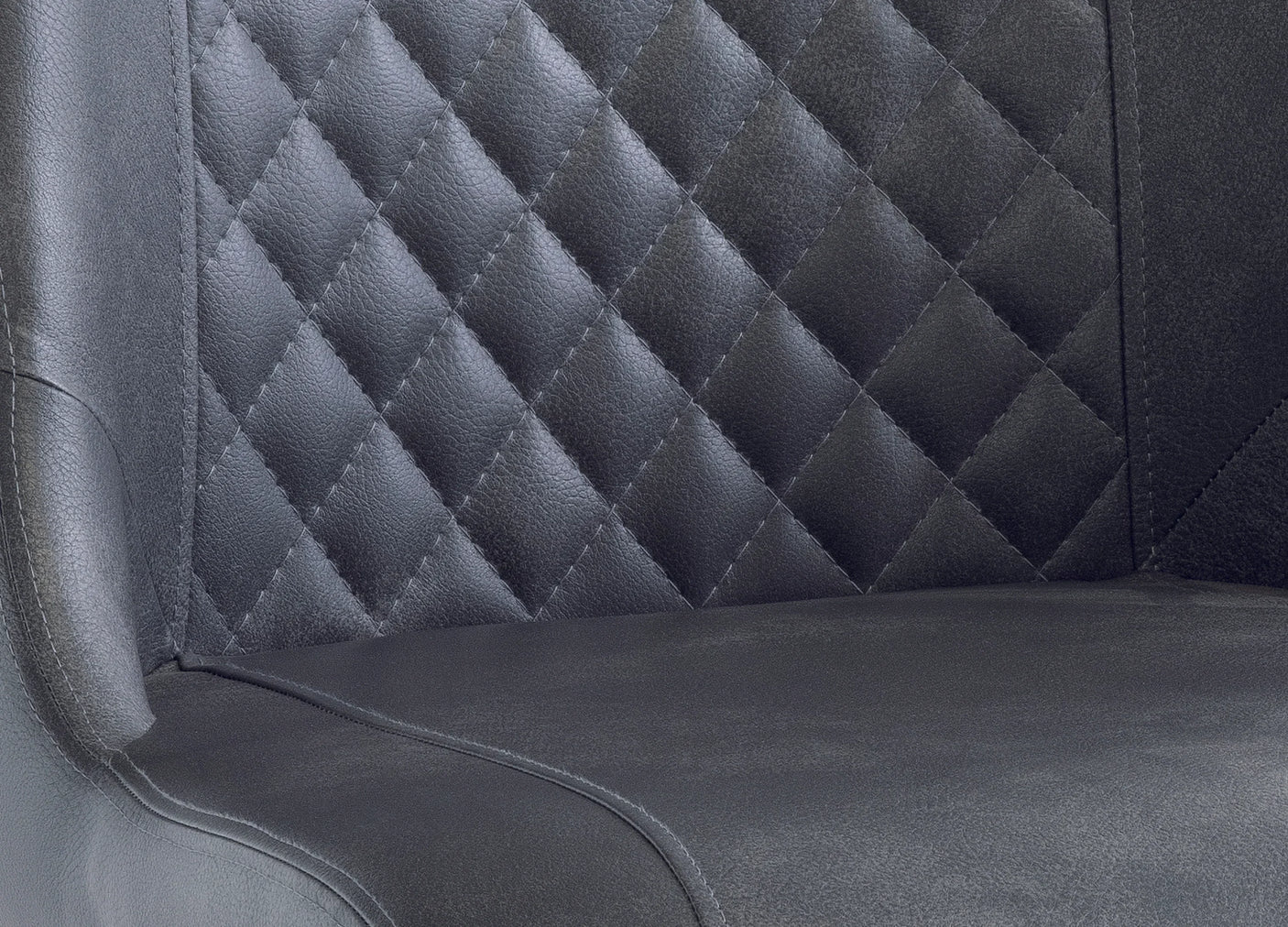 Close up of black faux leather dining chair with quilted diamond stitched backrest