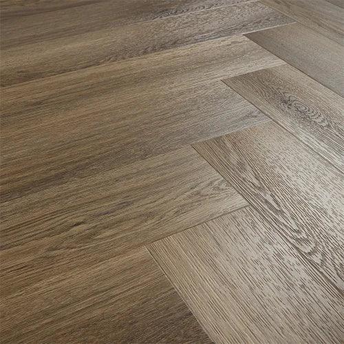 Antique walnut wood flooring in herringbone pattern with natural grain texture