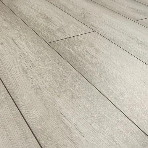 Arctic oak laminate flooring planks with light grain texture and matte finish