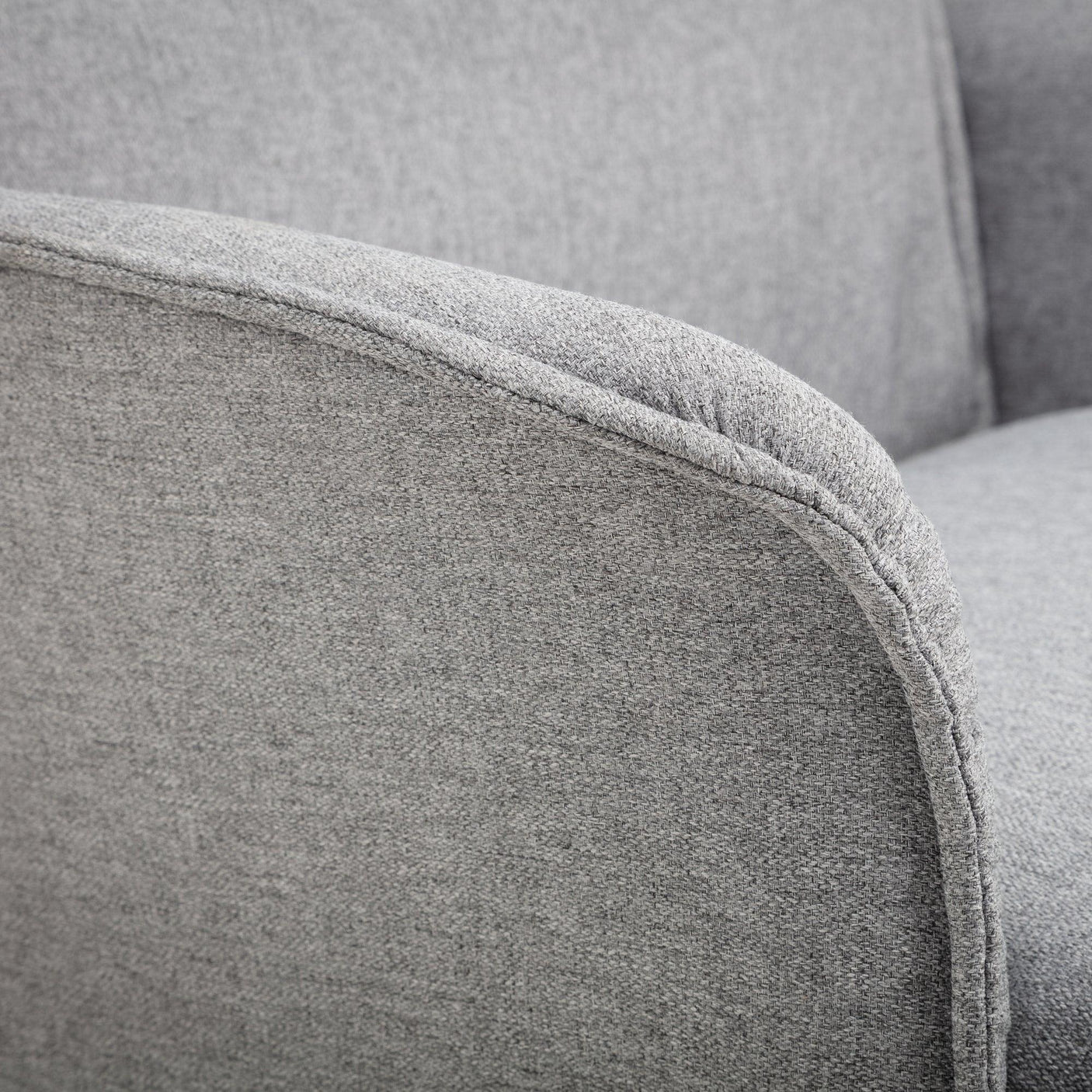 Close-up of fabric recliner armrest in light grey upholstery