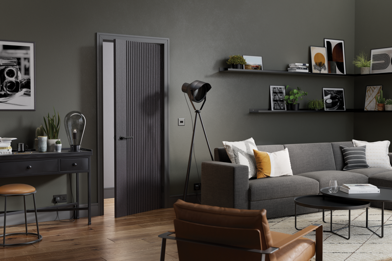 Ash grey sectional sofa with scatter cushions in modern living room, wall shelves, wooden flooring
