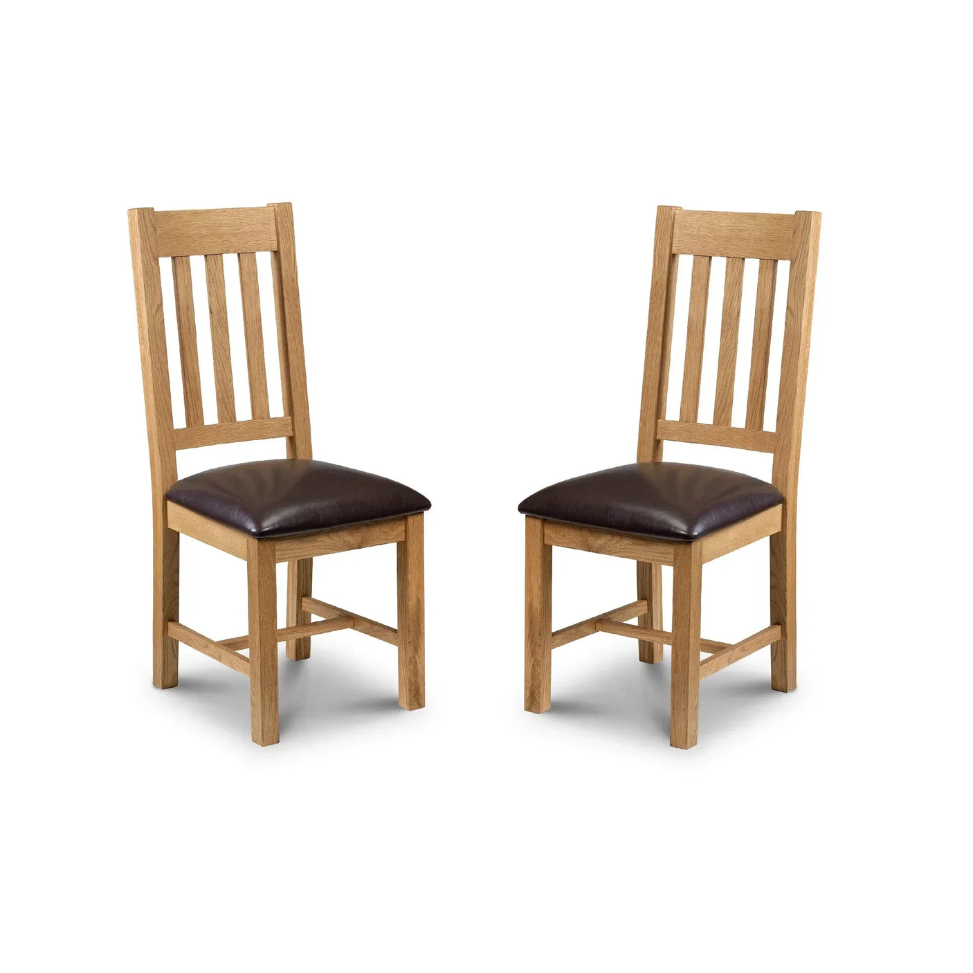 Set of two oak dining chairs with slatted backs and brown faux leather seat pads