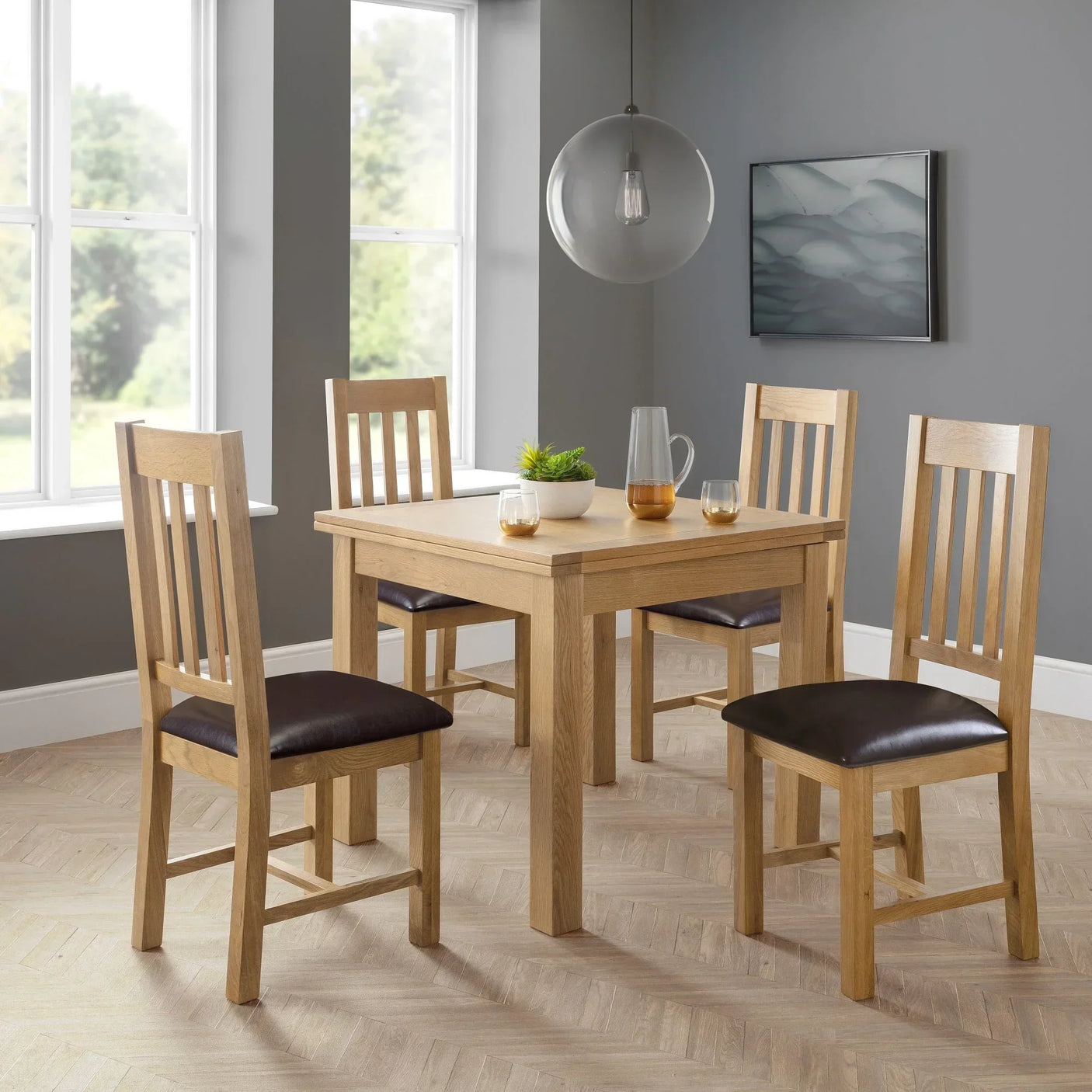 Oak dining table with four matching slat-back chairs in modern dining room
