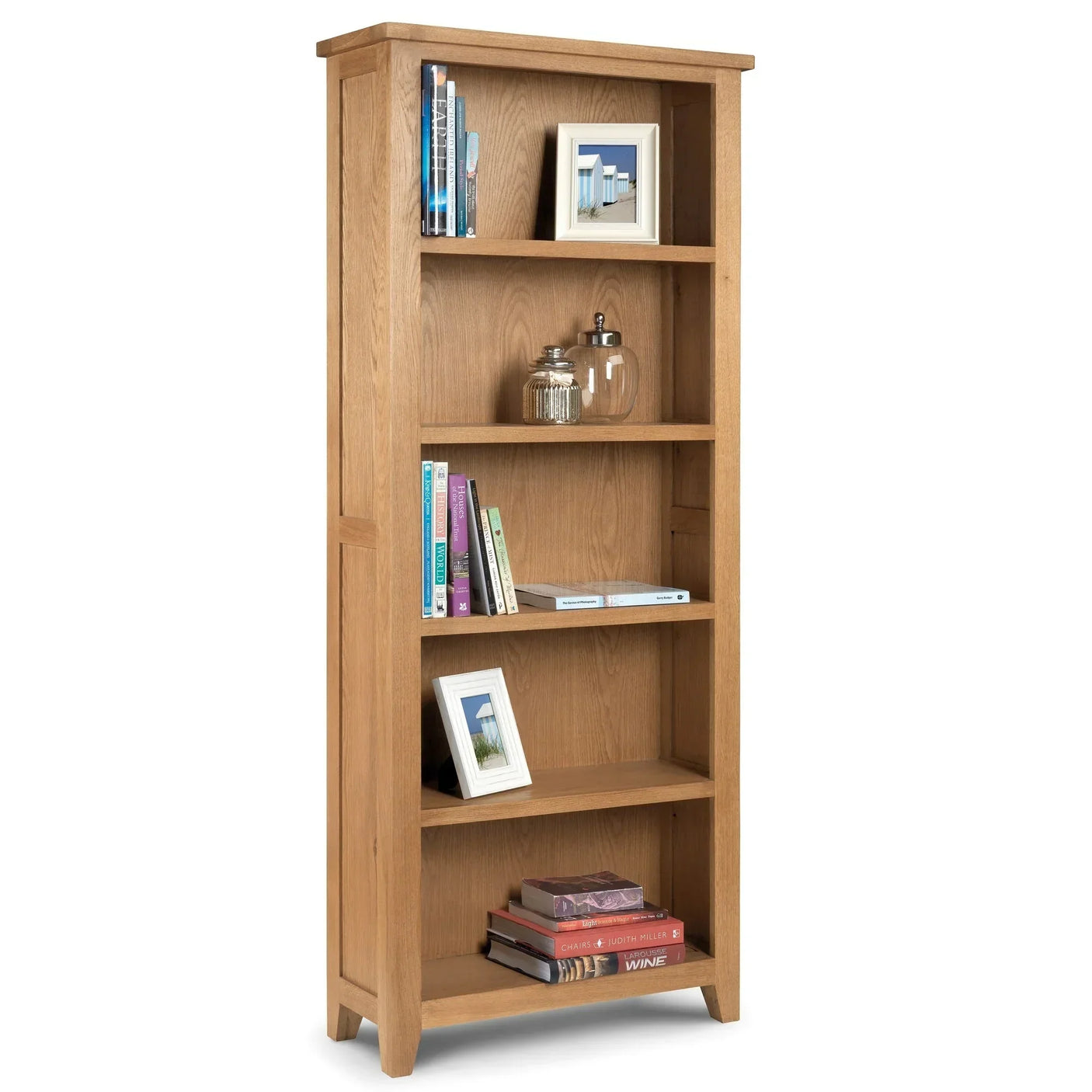 Oak tall bookcase with five shelves, books, glass jars, and framed photos on display