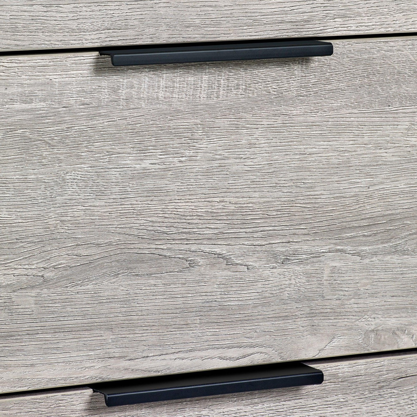 Grey oak chest of drawers close-up showing wood grain and modern black handles