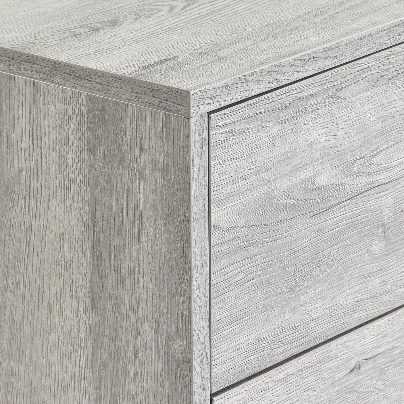 Grey oak chest of drawers corner detail showing textured wood grain finish