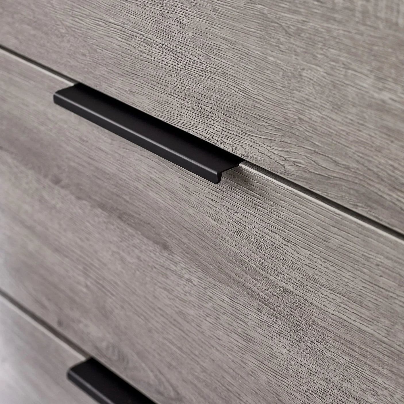 Closeup of Bali 6 drawer chest in grey wood finish with black metal handle