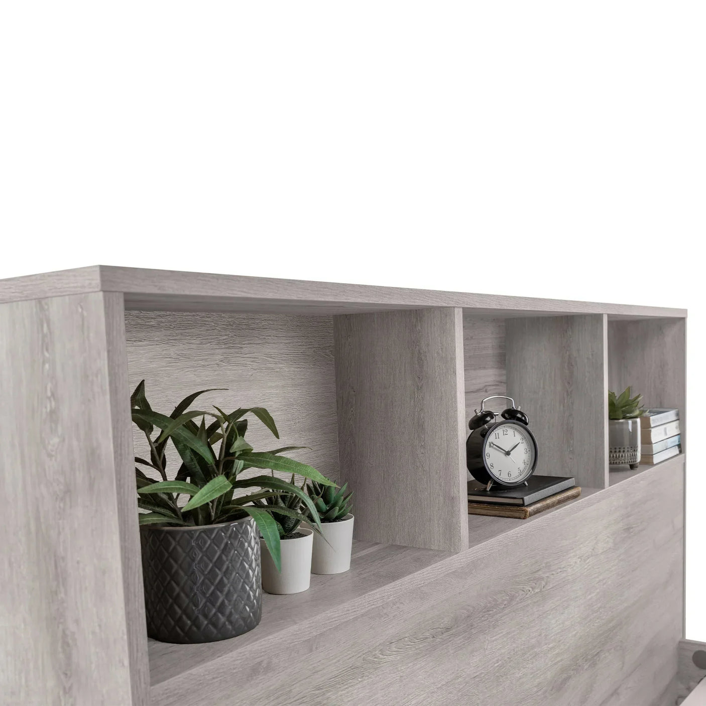 Grey oak bookcase double bed headboard with open shelves, plants, clock, and books