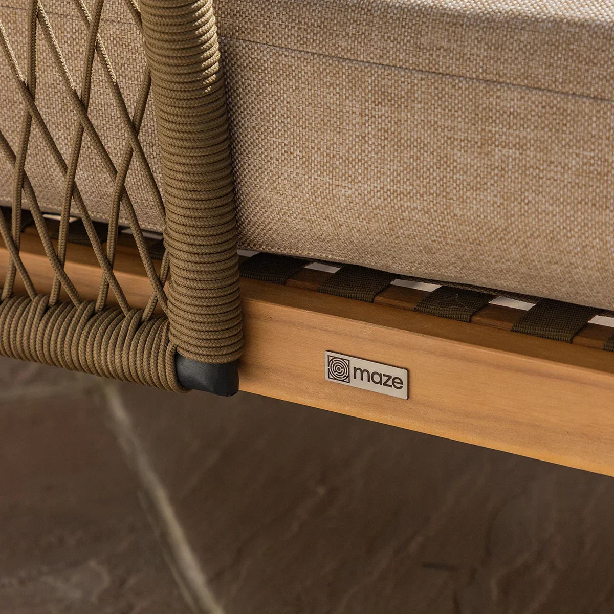 Close-up of rope detail and beige cushion on outdoor sofa with wooden frame
