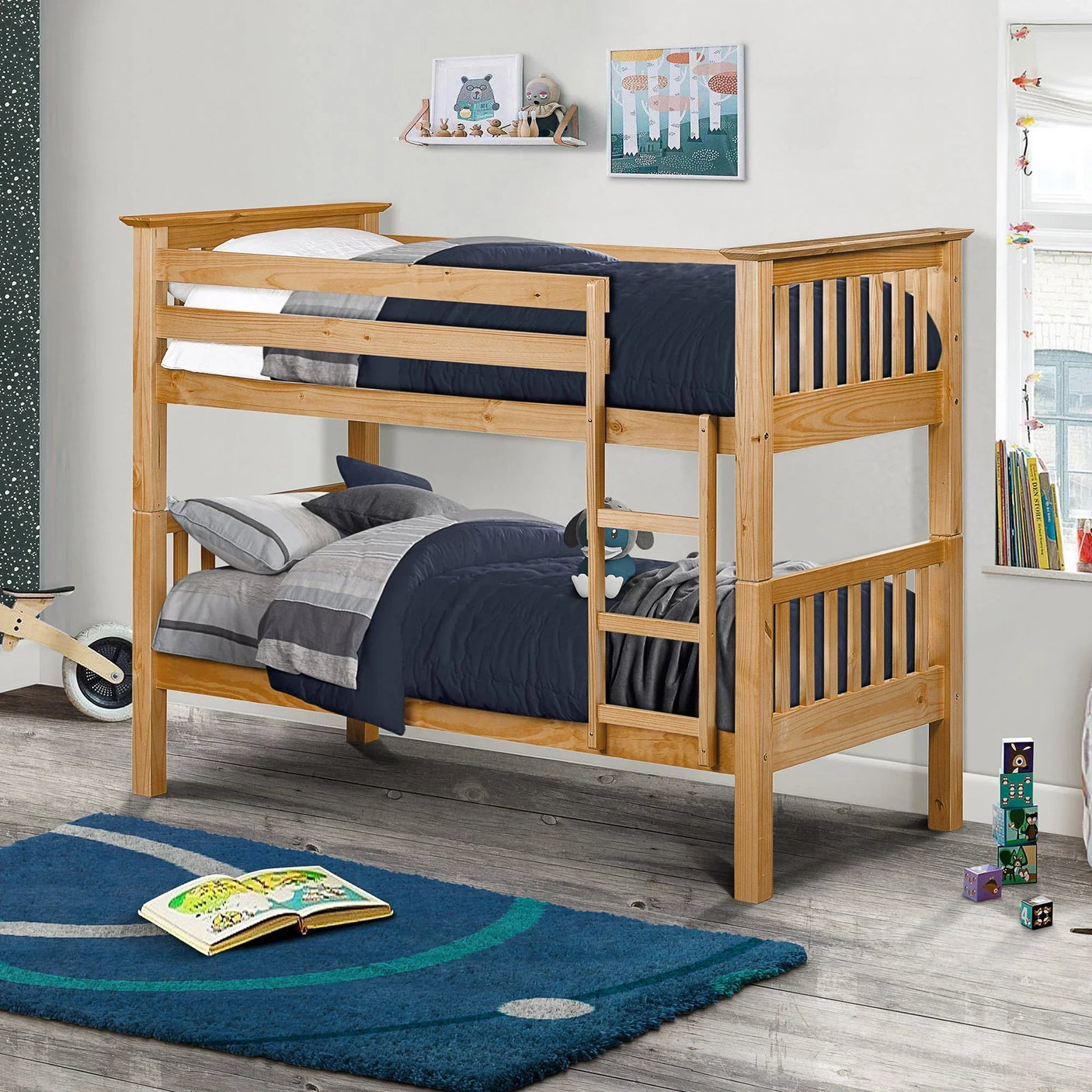 Pine bunk bed with ladder in kids’ bedroom, navy bedding, wooden floor, playful decor