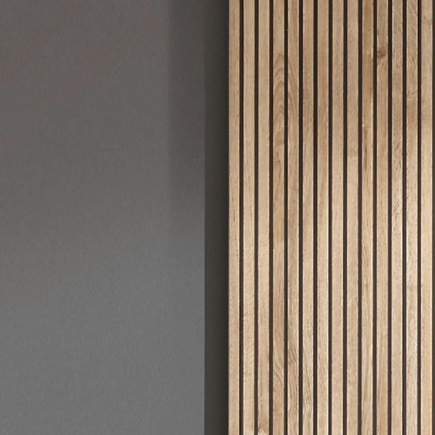 Oak wood slat wall panel beside smooth grey painted wall