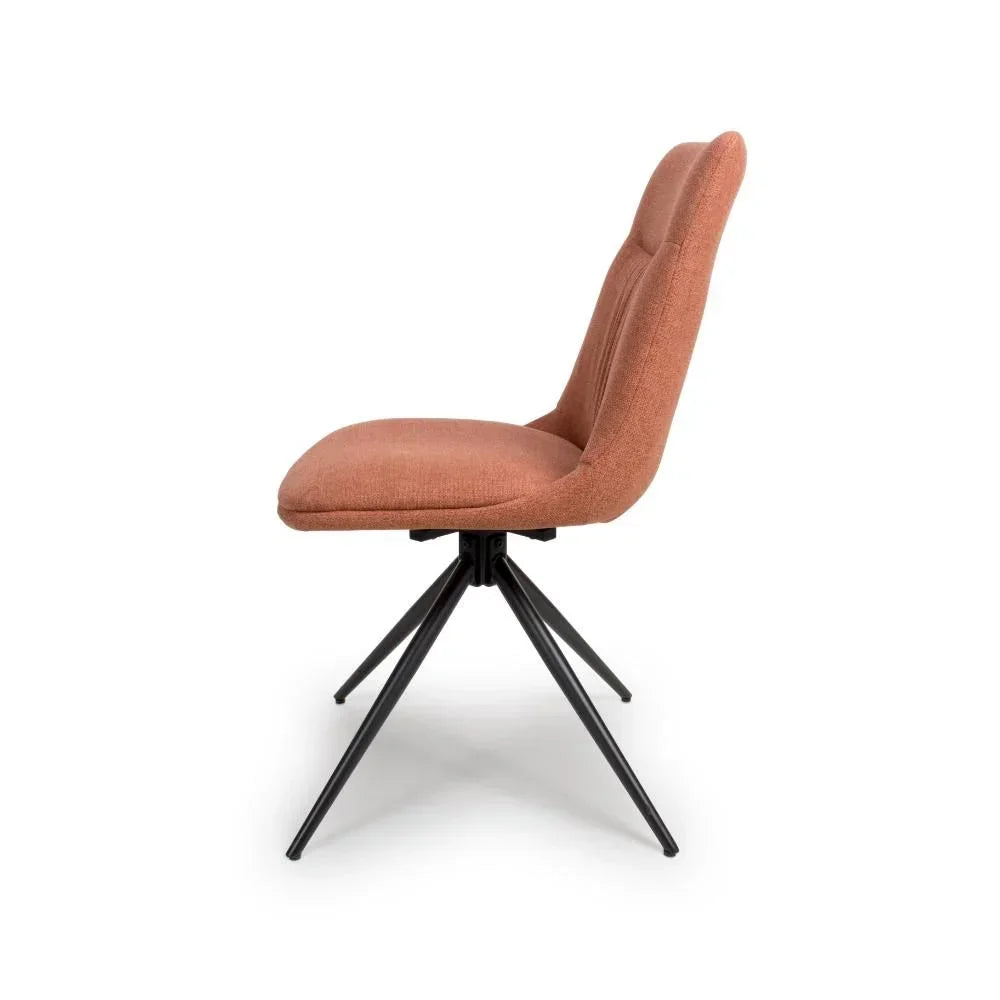 Rust fabric dining chair with black metal legs, side profile view on white background