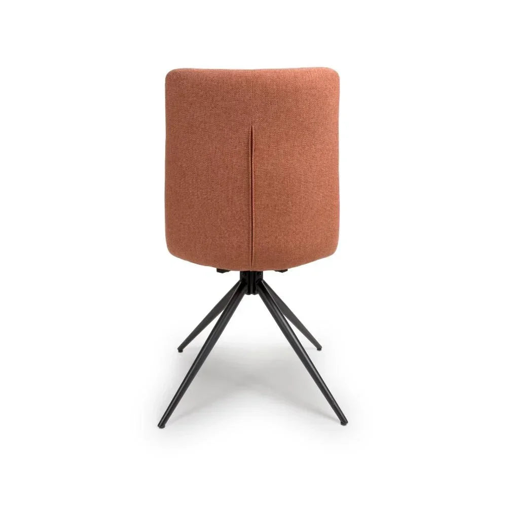 Rust fabric dining chair with black metal legs, rear view