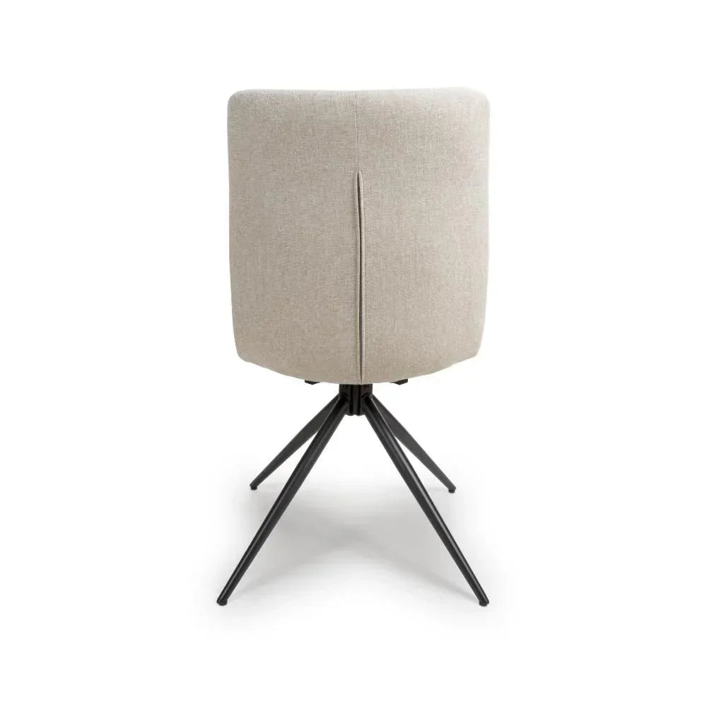 Beige fabric dining chair rear view with black metal legs