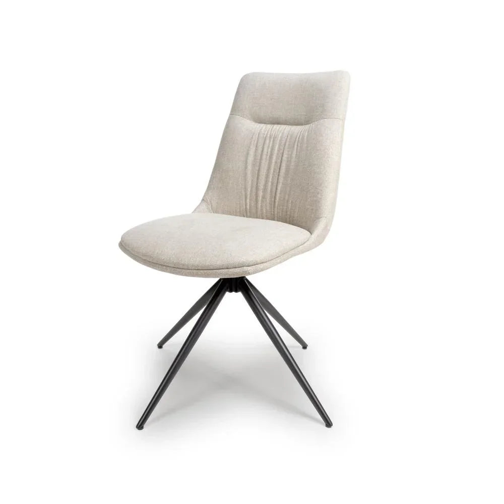 Beige fabric dining chair with padded seat and black angled metal legs