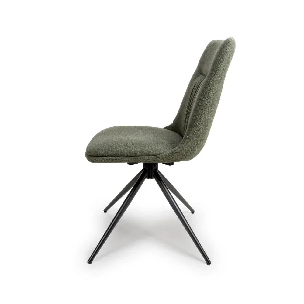 Side view of grey upholstered dining chair with black metal legs