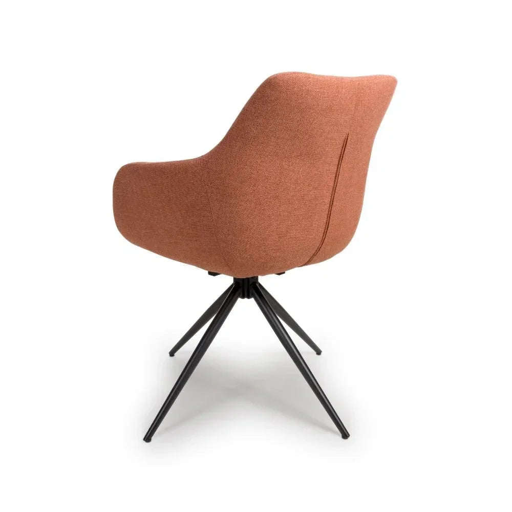 Back view of rust fabric accent chair with black metal legs