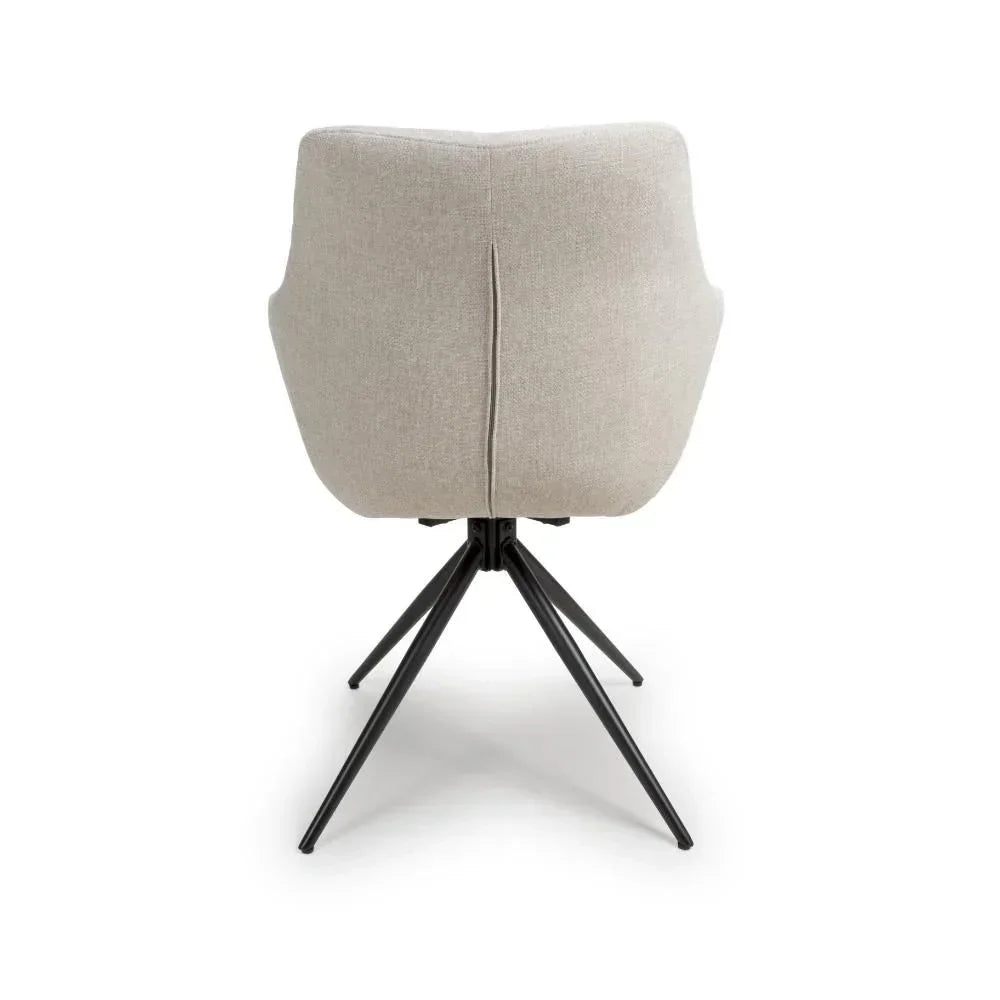 Beige upholstered dining chair rear view with black metal legs