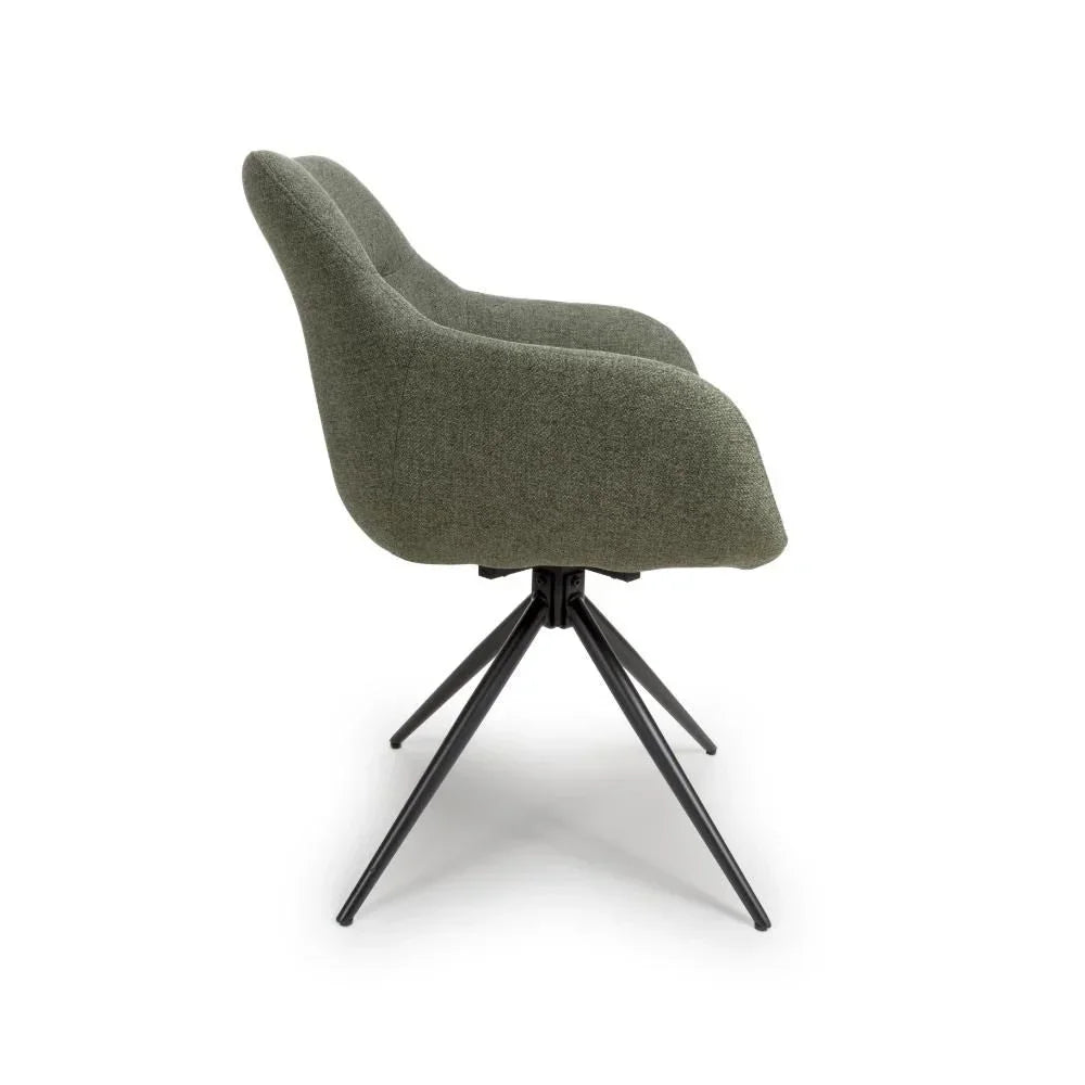 Side view of green fabric dining chair with black metal legs