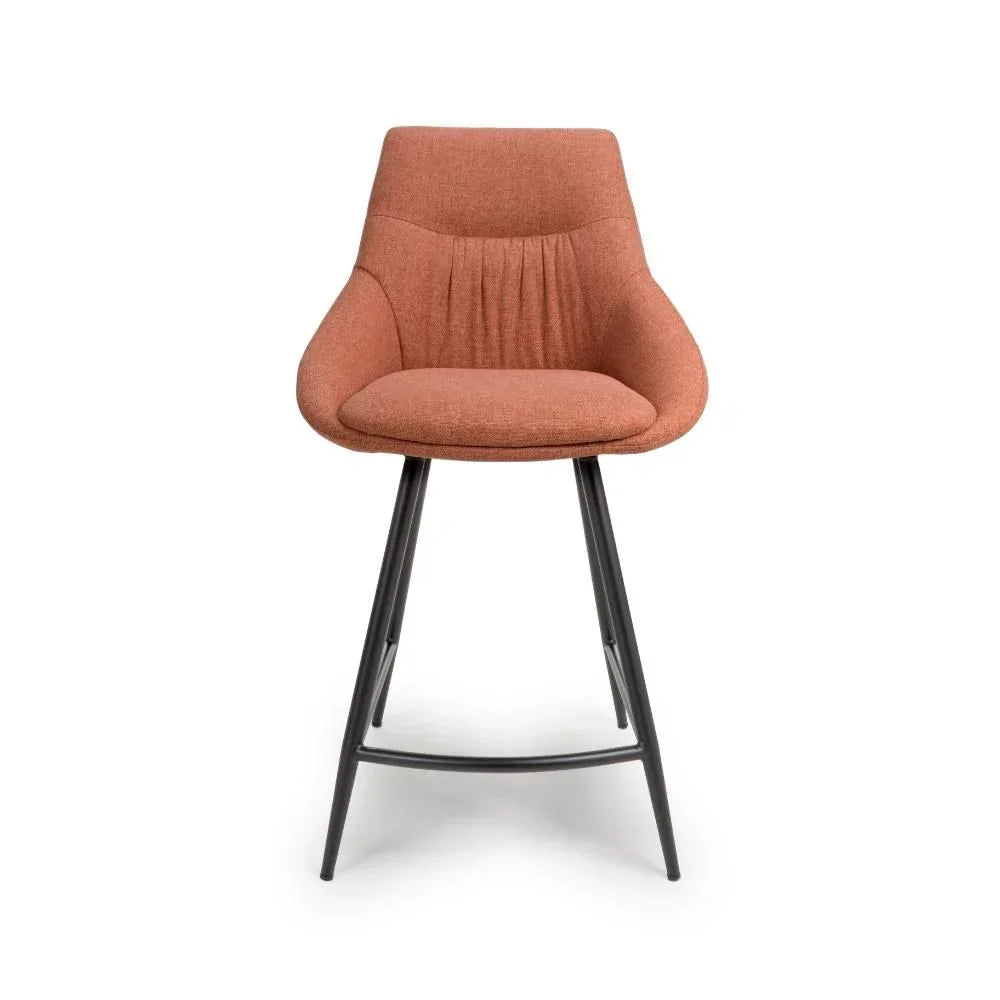 Rust fabric bar stool with curved backrest and black metal legs, front view