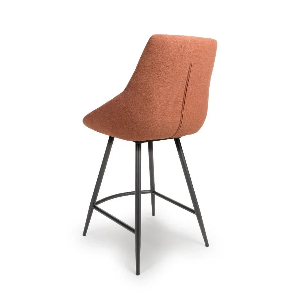 Rust fabric bar stool with metal legs, angled rear view highlighting the curved backrest