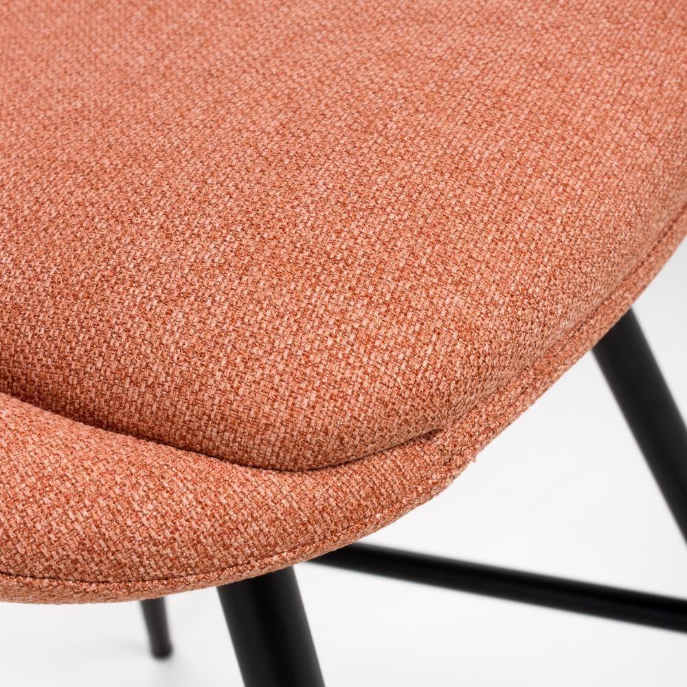 Close view of orange fabric dining chair seat with black metal legs