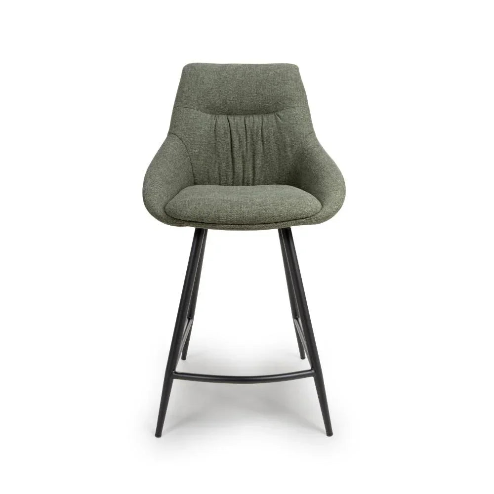 Green fabric bar stool with curved back and black metal legs on white background