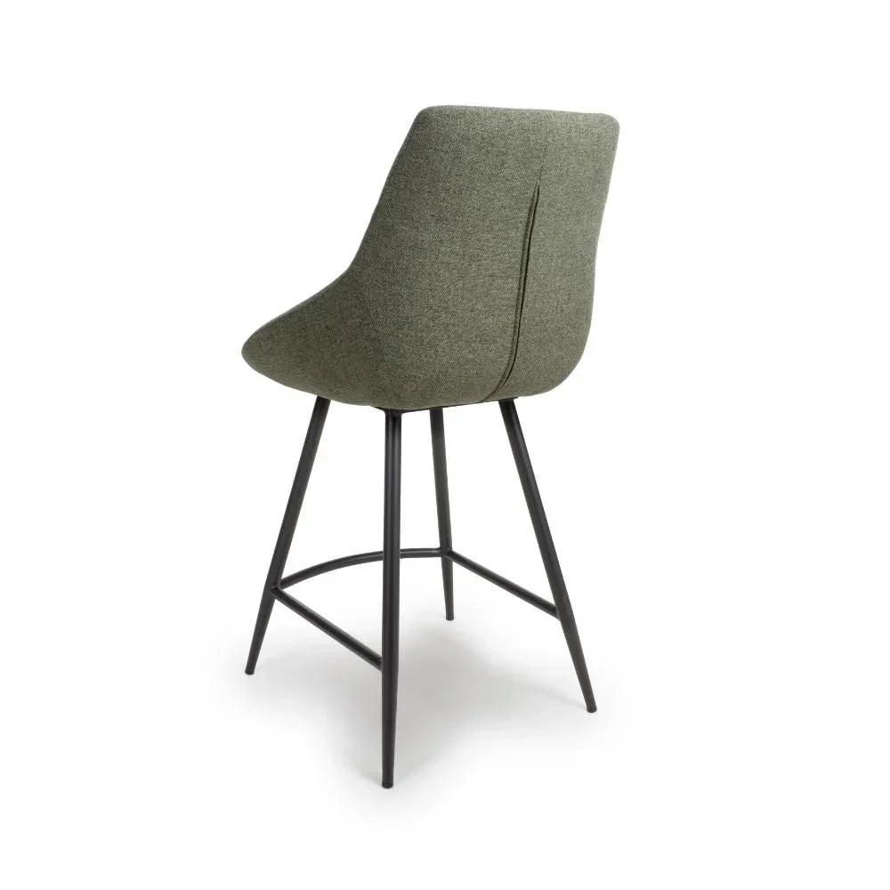 Green upholstered bar stool with metal legs, rear view highlighting backrest seam