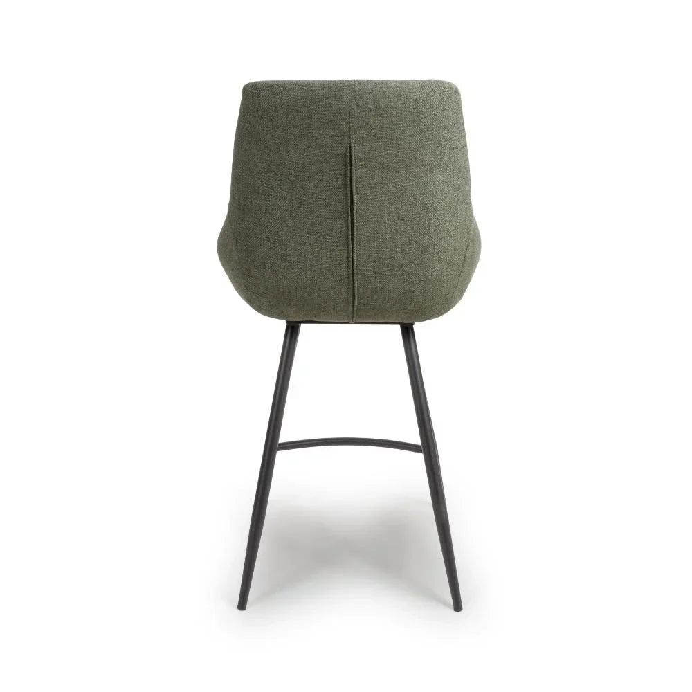 Green fabric bar stool with curved backrest and black metal legs, rear view