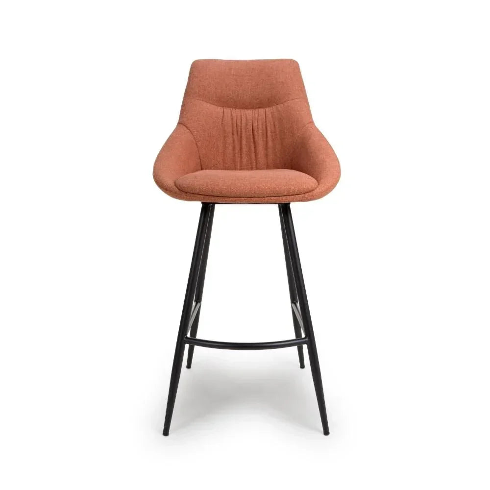 Rust fabric bar stool with curved backrest and black metal legs front view