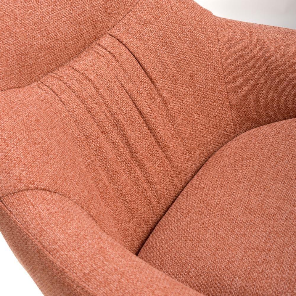 Closeup of rust fabric armchair with curved backrest and stitched detailing