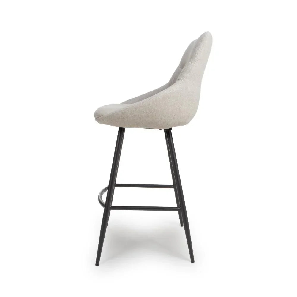Light grey fabric bar stool with black metal legs and footrest, side profile view