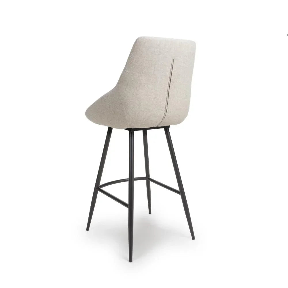 Beige fabric bar stool with black metal legs, rear view
