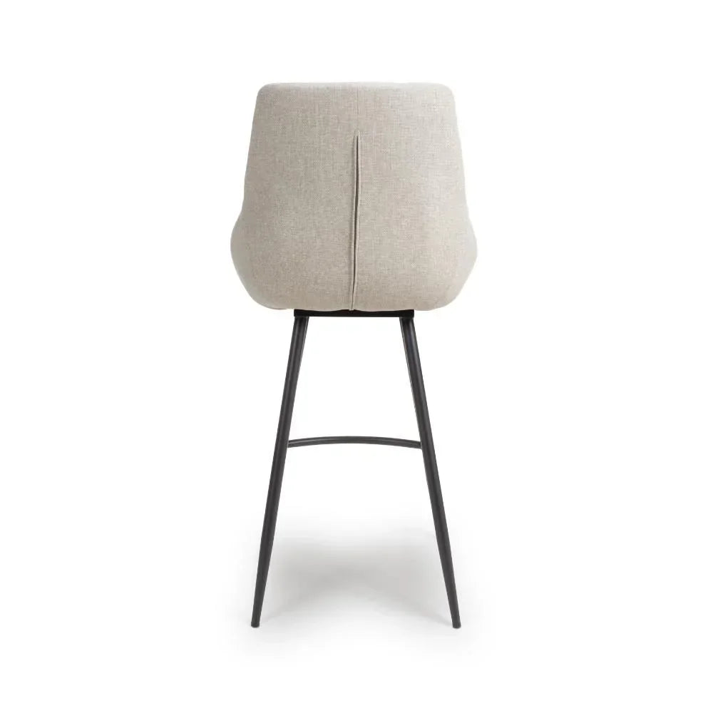 Beige fabric bar stool with black metal legs, rear view