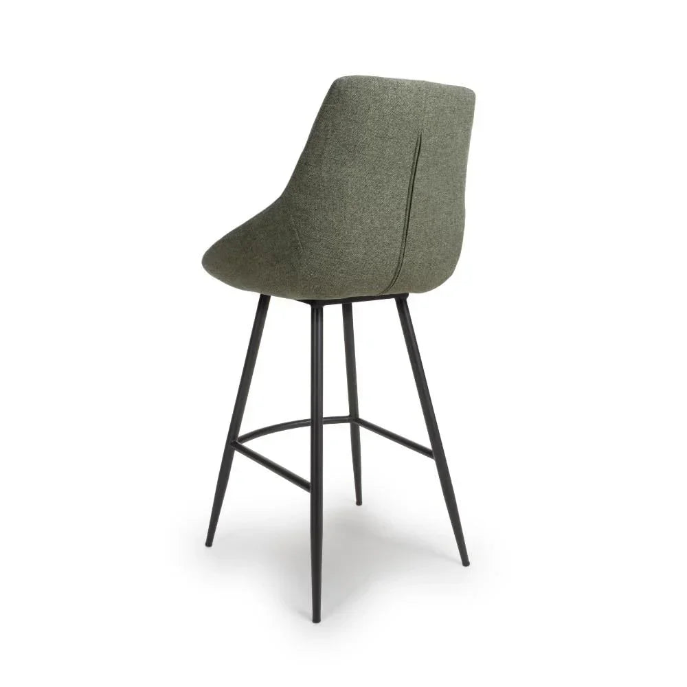 Green fabric bar stool with curved backrest and black metal legs, rear angle view