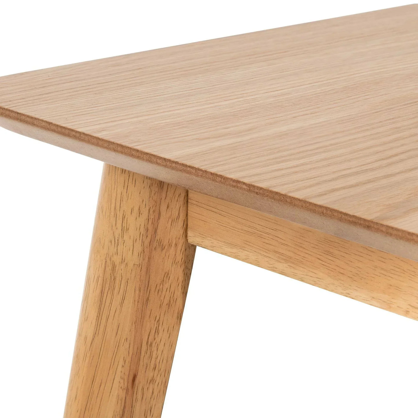 Close-up of rectangular oak dining table corner with wood grain detail