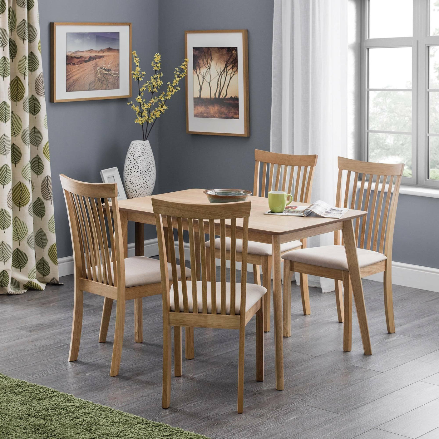 Rectangular oak dining table with four slatted back chairs in modern dining room