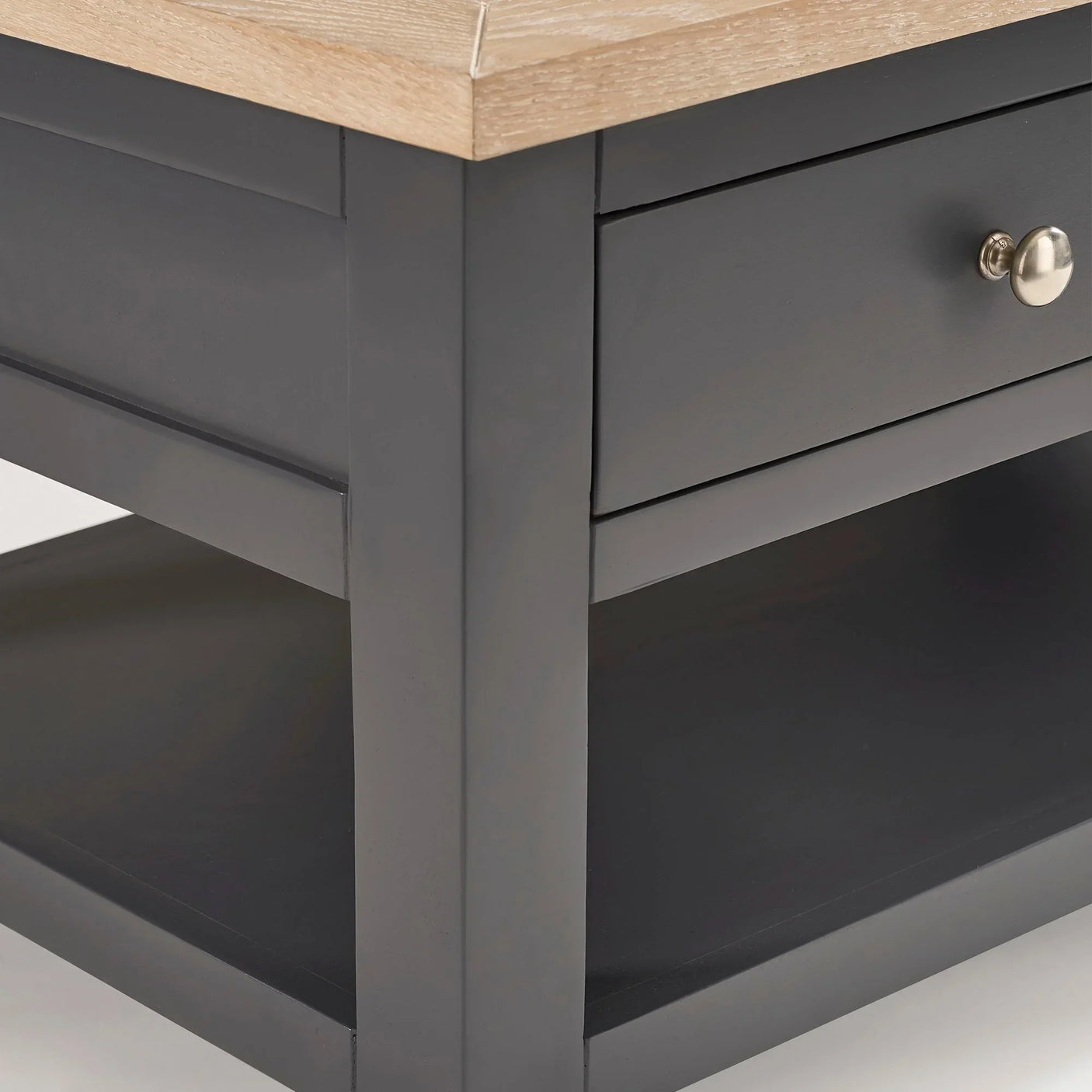 Bordeaux coffee table corner with dark frame, oak top, drawer and lower shelf detail