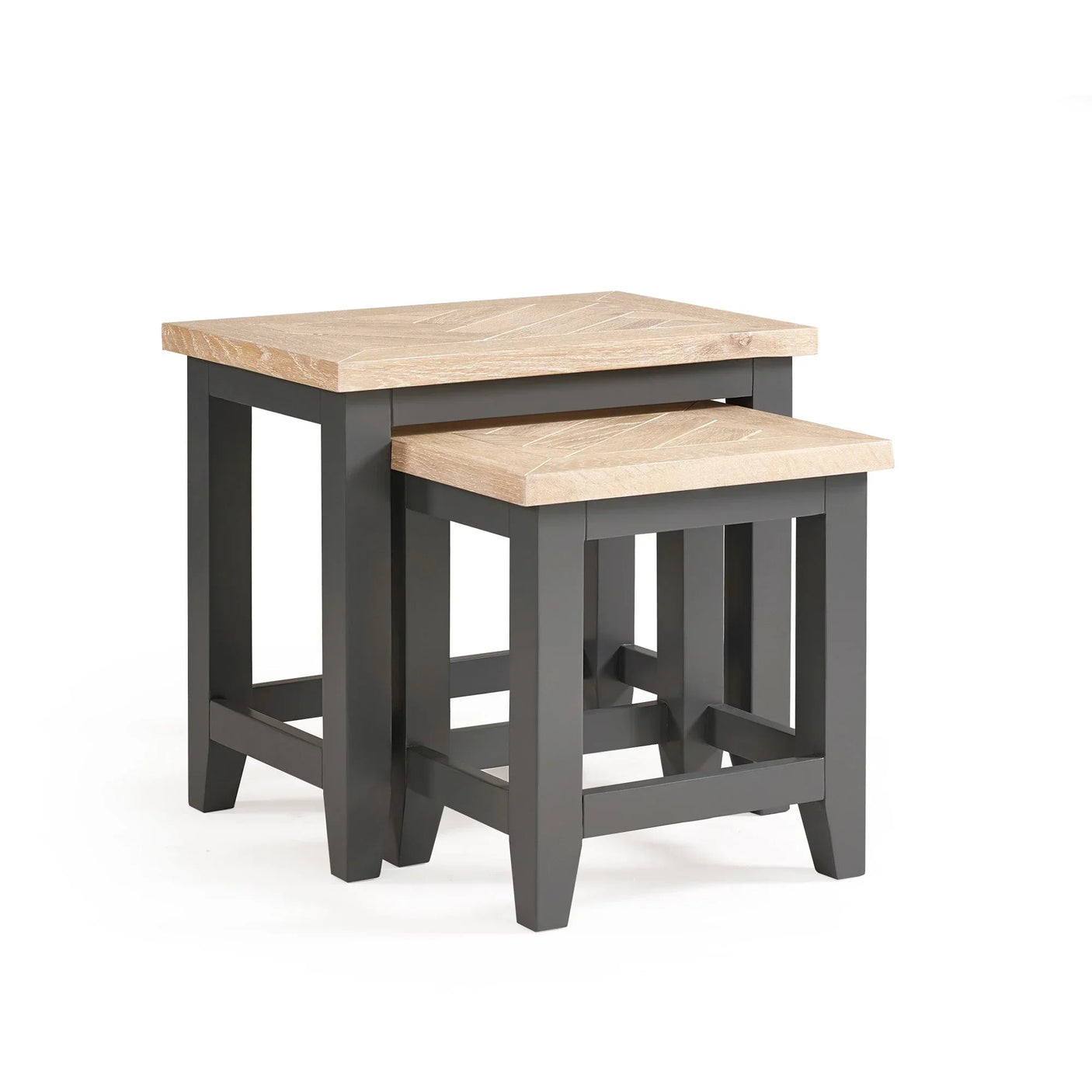 Set of two nesting tables with light wood tops and black legs on white background