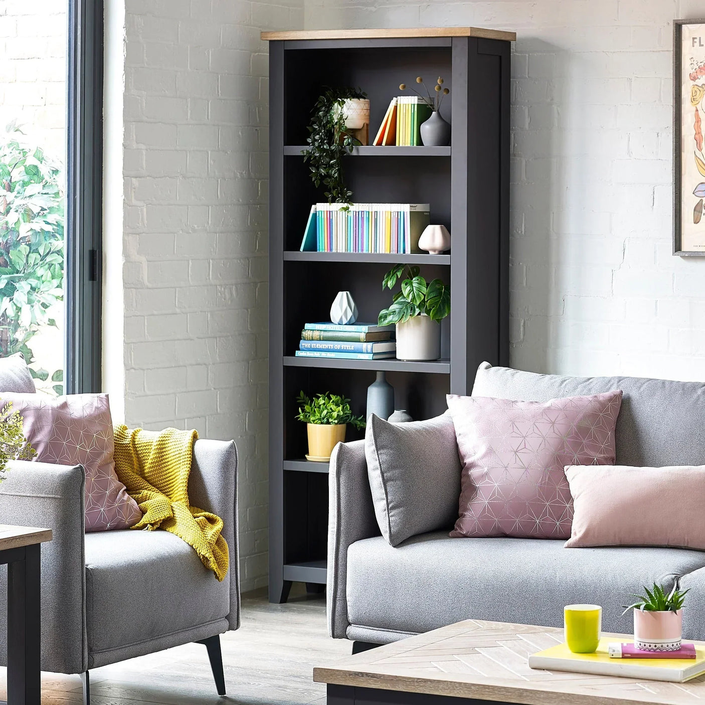 Bordeaux tall bookcase with wood top styled with books, decor, and plants in living room