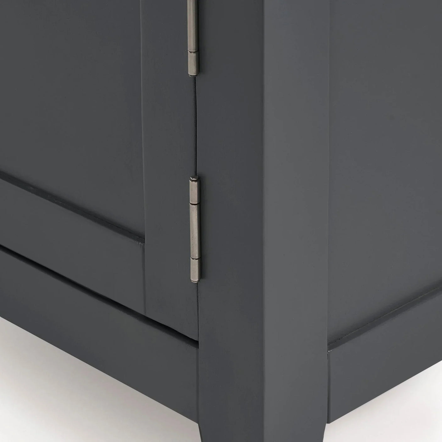 Close-up of grey cabinet door with metal hinge and smooth painted wood finish