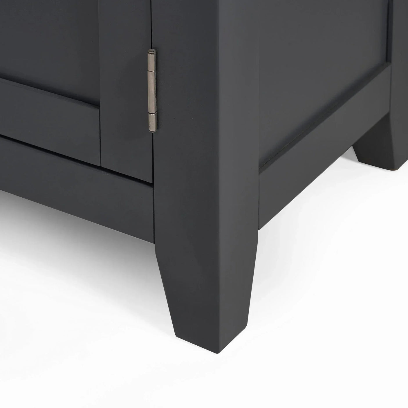 Close-up of dark grey sideboard corner with panel legs and metal hinge detail