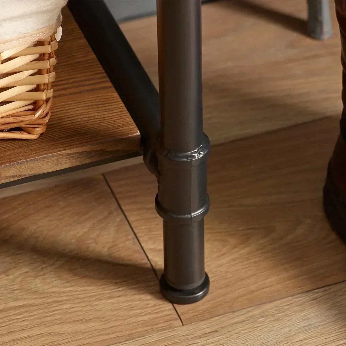 Metal leg and wood shelf detail of hallway bench on oak floor