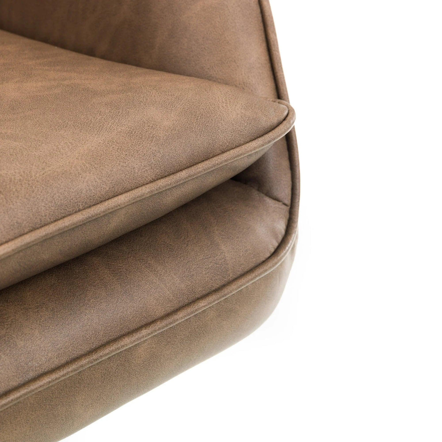 Close up of brown faux leather sofa cushion and piped edge detail