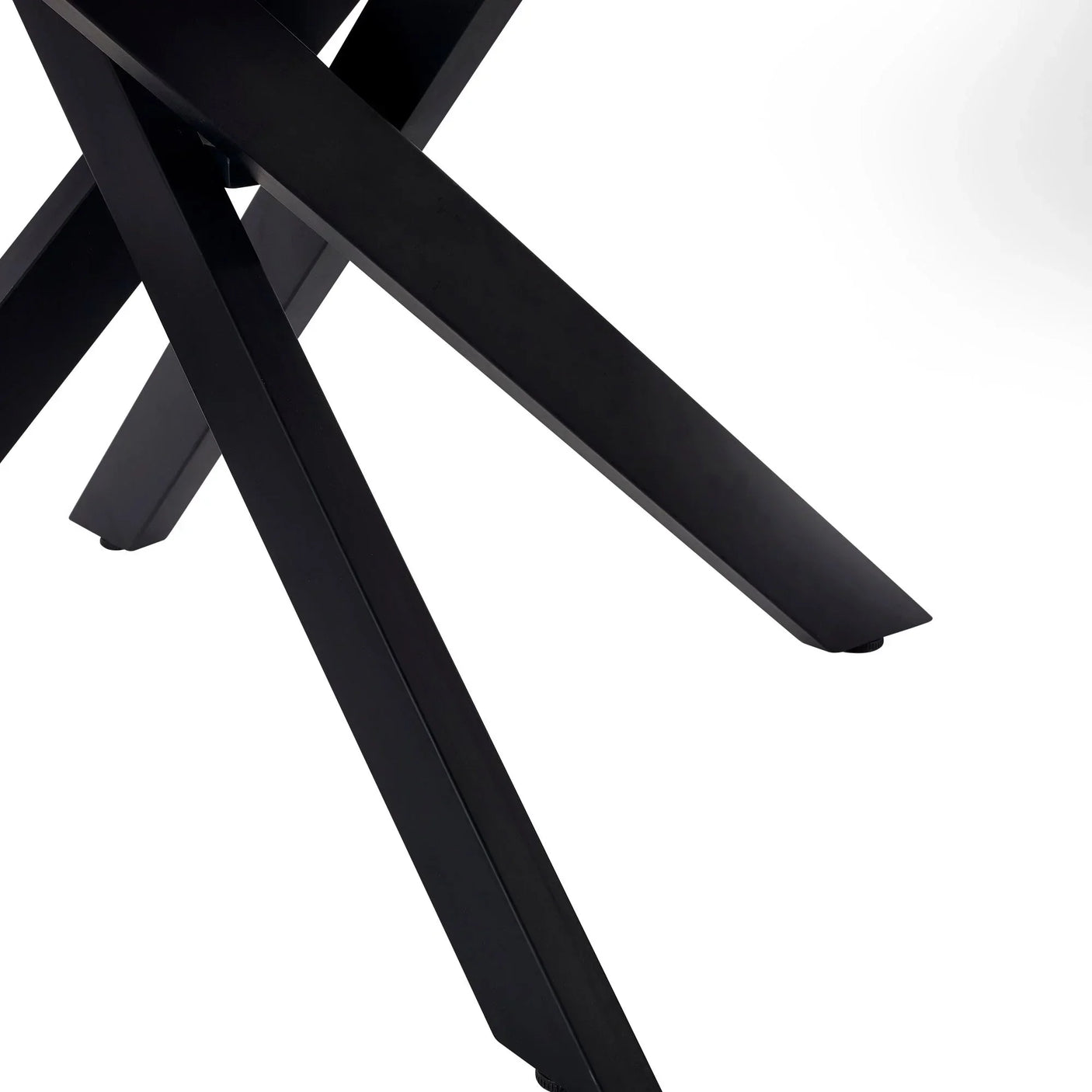 Black metal crossed legs of white marble dining table, detailed close-up view