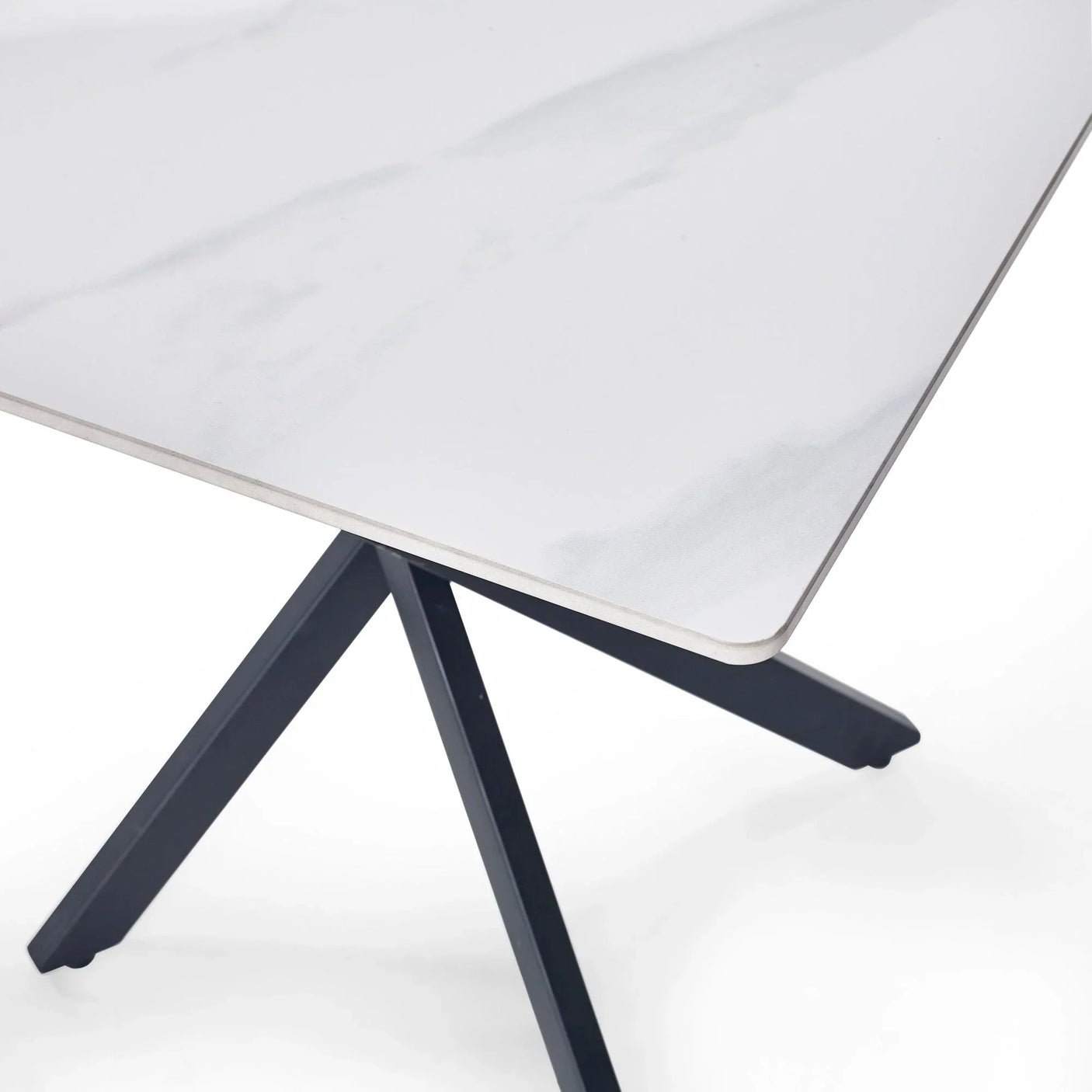 White marble lamp table with black angled legs, close-up on tabletop corner and base